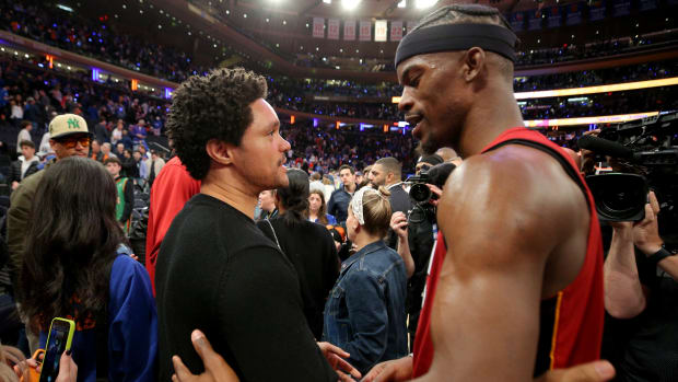Trevor Noah talks to Miami Heat forward Jimmy Butler after a game.